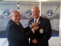 Gold pin for Neil Bryant